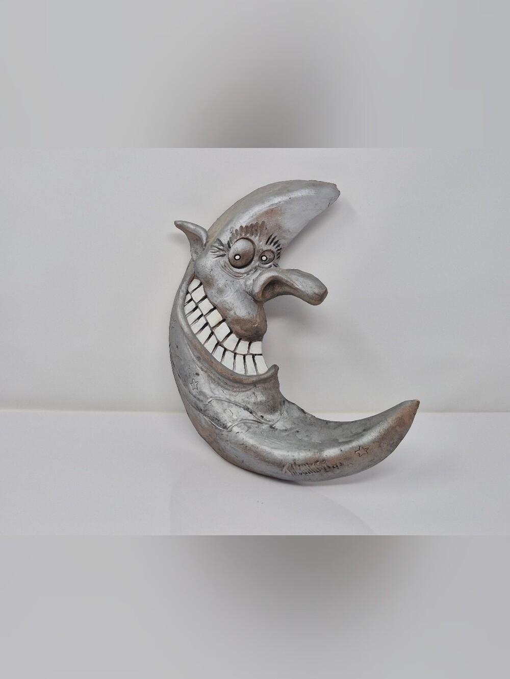 Silver Crescent Moon With Large Nose And Teeth Pottery? Wall Hanging